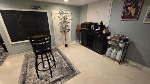 a room with a black chair and a chalkboard at Clinker Cottage Garden Apartment - Free Breakfast! in Albany