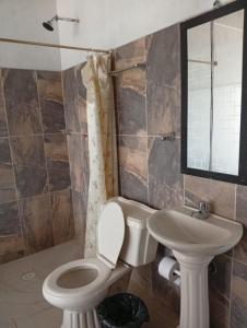 a bathroom with a toilet and a sink at CASA HOTEL EL PRADo in Mesetas