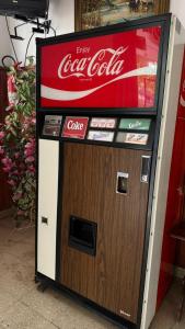 a coca cola machine with a sign on it at Hotel San Carlos in Mar del Plata