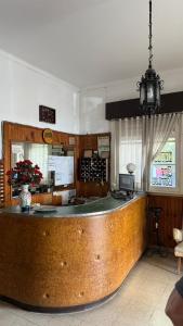 a large kitchen with a bar in a restaurant at Hotel San Carlos in Mar del Plata