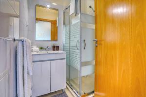 a bathroom with a glass shower and a sink at Vilamar 2 - Madeira Inn Group in Calheta