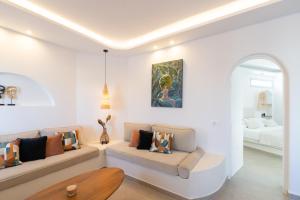 a living room with a couch and a bed at SN Santorini Apartments in Kamari +55 photos