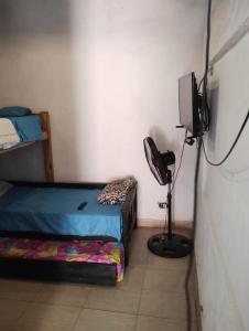 a room with two beds and a television in it at Trotamundo in Los Polvorines
