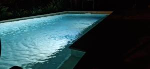 a swimming pool at night with clouds in the water at House with a heated pool for your exclusive use in Santa Brígida