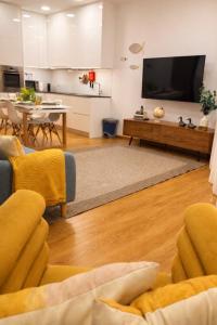 a living room with a couch and a tv at Almeida's House in Viana do Castelo