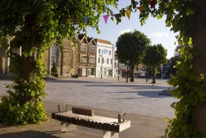 a park bench in front of a building at The Chapter House in Salisbury