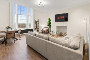 a living room with a large couch and a table at Spacious 2 Bed Apartment With Secure Free Parking in Liverpool