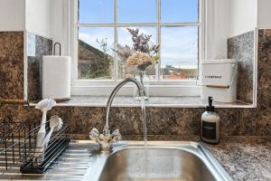a sink in a kitchen with a window at Spacious 2 Bed Apartment With Secure Free Parking in Liverpool +62 photos