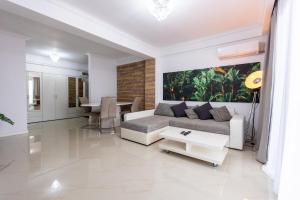 a living room with a couch and a table at White Residence Steaua De Mare in Eforie Nord