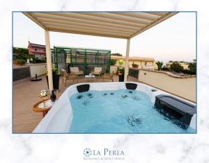 a hot tub on the roof of a house at La Perla Guest house in Stalettì