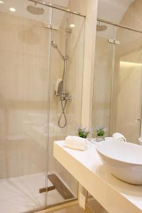 a bathroom with a sink and a glass shower at Almeida's House in Viana do Castelo +6 photos