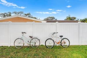 two bikes parked next to a white fence at 332 Formosa Drive in Cocoa Beach +24 photos