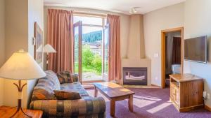 a living room with a couch and a fireplace at Cahilty #110 home in Sun Peaks