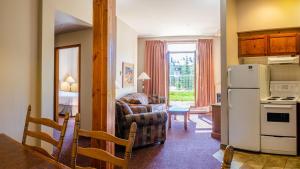 a kitchen and a living room with a refrigerator at Cahilty #110 home in Sun Peaks