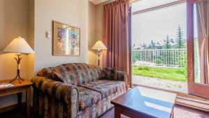 a living room with a couch and a large window at Cahilty #110 home in Sun Peaks
