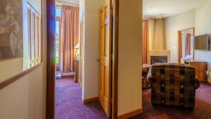 a hotel room with a door leading to a living room at Cahilty #110 home in Sun Peaks