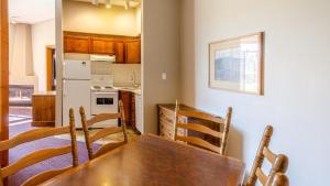 a kitchen with a table and chairs in a room at Cahilty #110 home in Sun Peaks +11 photos