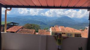 a little girl standing on the edge of a wall at Hotel y parqueadero La Colonia Inn in Socorro