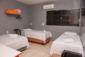 a hospital room with two beds and a window at Hotel Nacional in Jataí +28 photos