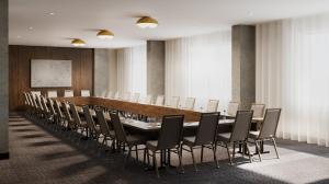 a conference room with a long table and chairs at Metcalfe Hotel Montréal by Gray Collection in Montreal +39 photos