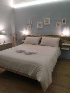 a bedroom with a large bed with two towels on it at Arthouse in Molfetta