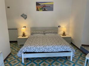 a bedroom with a bed with two tables and two lamps at Affittacamere l'Acciuga in La Spezia