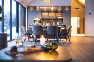 a dining room with a table and chairs in a room at LyNora - A private fjord retreat in Indre Ravelseidet