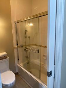 a bathroom with a glass shower with a toilet at A cozy en-suite on the second floor with independent entranceclose to YVR in Richmond