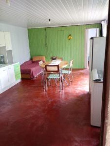 a room with a table and chairs and a bedroom at cabanas sossego in Água Boa
