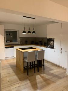 a kitchen with a table and chairs in a room at Familiehus in Nakskov