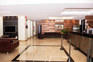 a lobby with couches and a table in a building at Hotel Nacional in Jataí