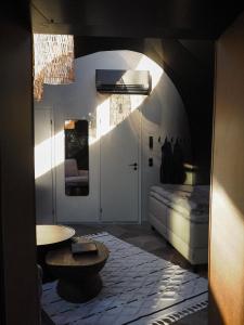 a hallway with a table and a bed in a room at Taju Resort in Manniva +43 photos
