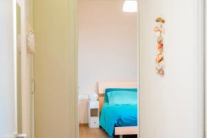 a bedroom with a bed with a blue bed at Sunset Terrace Sorrento Coast in Sant'Agnello