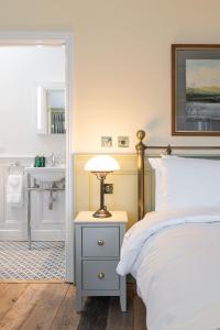 a bedroom with a bed and a sink at Ha'penny View House in Dublin