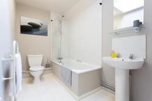 a white bathroom with a sink and a toilet at Beech Lodge Apartments, 2 Bed Apts close to Headington Hospitals in Oxford