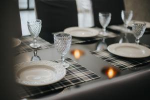 a table with plates and wine glasses on it at casa com piscina in Sinop