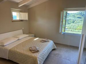 a bedroom with a bed with two towels on it at IL COLLE rooms in Lucca +10 photos