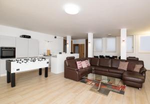 a living room with a couch and a table at Private Paradise Nuremberg in Nuremberg