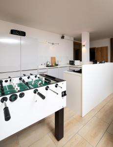 a large white kitchen with a ping pong table at Private Paradise Nuremberg in Nuremberg