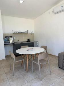 a table and chairs in a room with a kitchen at Estación Destino in El manzano historico +17 photos