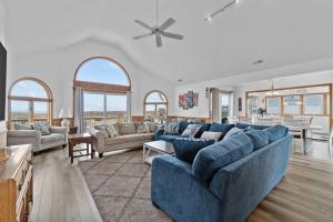 a living room with a blue couch and a table at 8180 - Looney Dunes in Waves