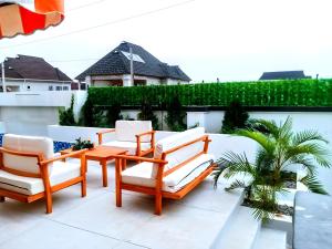a group of chairs and a table on a patio at Ifemide Estates - Luxury Homes in Akure