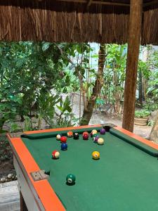 a pool table with balls on top of it at Pousada Coqueiro do Caitá in Morro de São Paulo