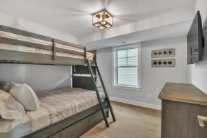 a bedroom with two bunk beds and a desk at 1220 A Asbury in Ocean City