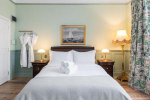 a bedroom with a bed with towels on it at Ha'penny View House in Dublin