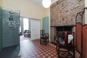 a bathroom with a brick wall and a fireplace at Ha'penny View House in Dublin +49 photos