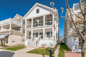 a white house with balconies on a street at 1220 A Asbury in Ocean City