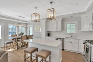 a kitchen with white cabinets and a table and chairs at 1220 A Asbury in Ocean City