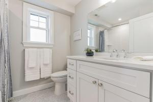 a white bathroom with a toilet and a sink at 1220 A Asbury in Ocean City +23 photos