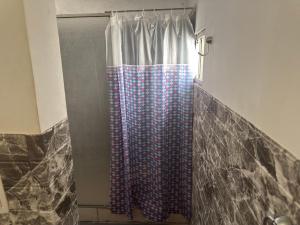 a shower with a shower curtain in a bathroom at Apartamento Lomas de Solymar in Ciudad de la Costa